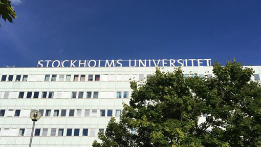 One of Stockholms University's hospital-looking buildings with sign.