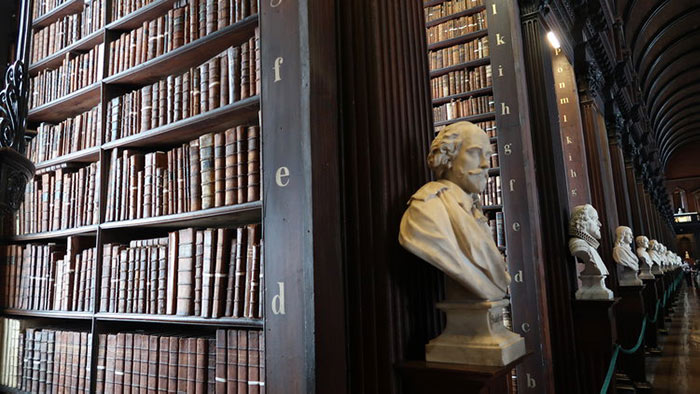 Bookshelves and marble busts in the Trinity College Library, Dublin.