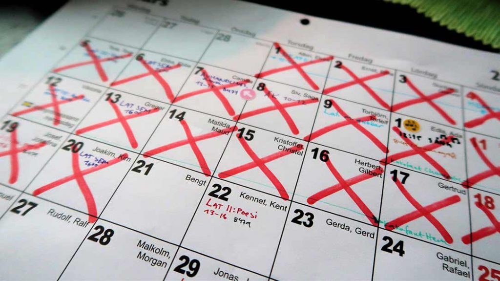 A calendar with big red crosses checking off almost the entire month as an illustration for having done your daily Latin habit.