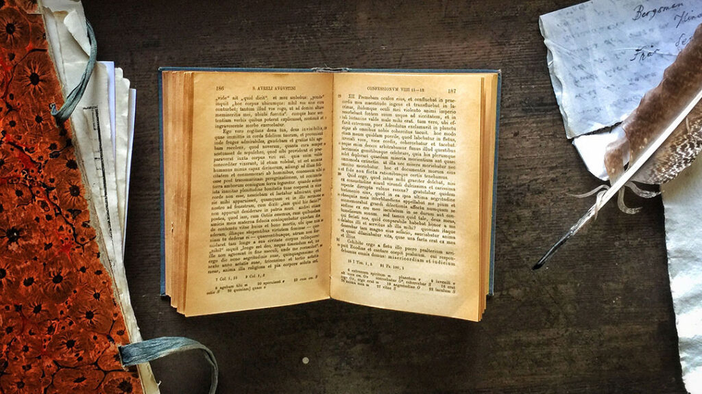 Augustinus' Confessiones in an open book on an old pulpet.